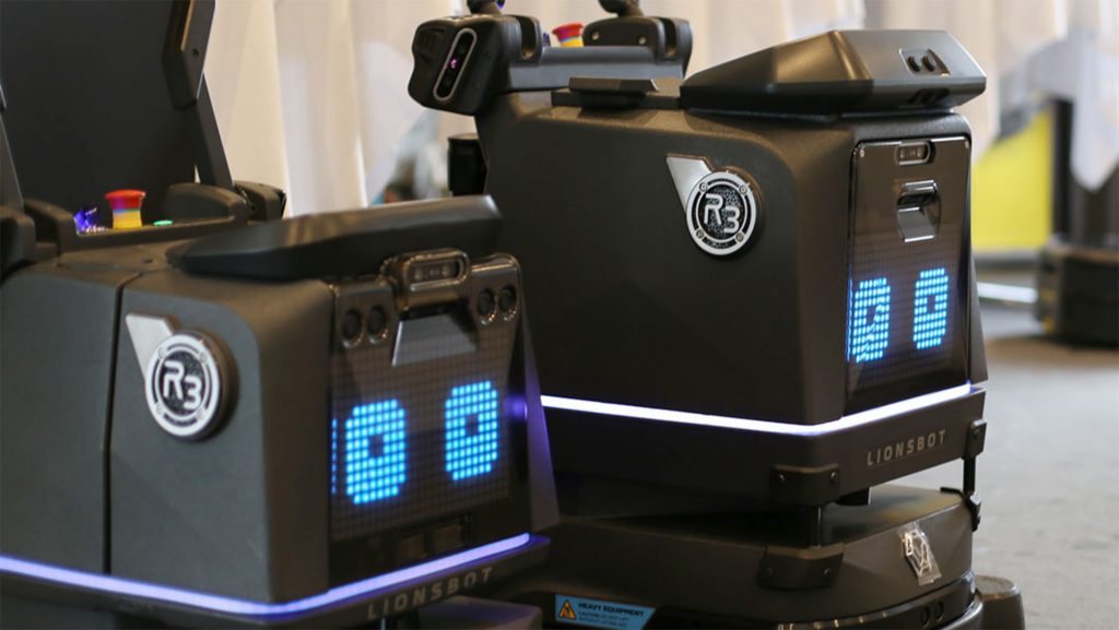 Close-up of two cleaning robots with digital displays and modern design — an example of automation in the cleaning industry.